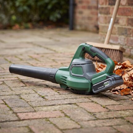 Gustwind 40V cordless leaf blower on a brick patio beside dry autumn leaves