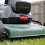 Close-up of the 60V battery pack seated in the Meridian mower housing