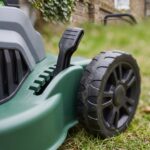 Close-up of the cutting-height adjustment lever and rear wheel on the Ridgeline mower