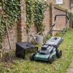 Ridgeline push mower on a small mown lawn beside a full grass bag