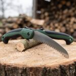 Sawtooth 13 inch folding pruning saw on a cut log with sawdust