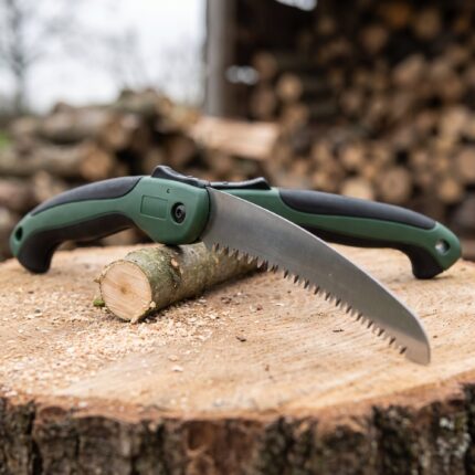 Sawtooth 13 inch folding pruning saw on a cut log with sawdust
